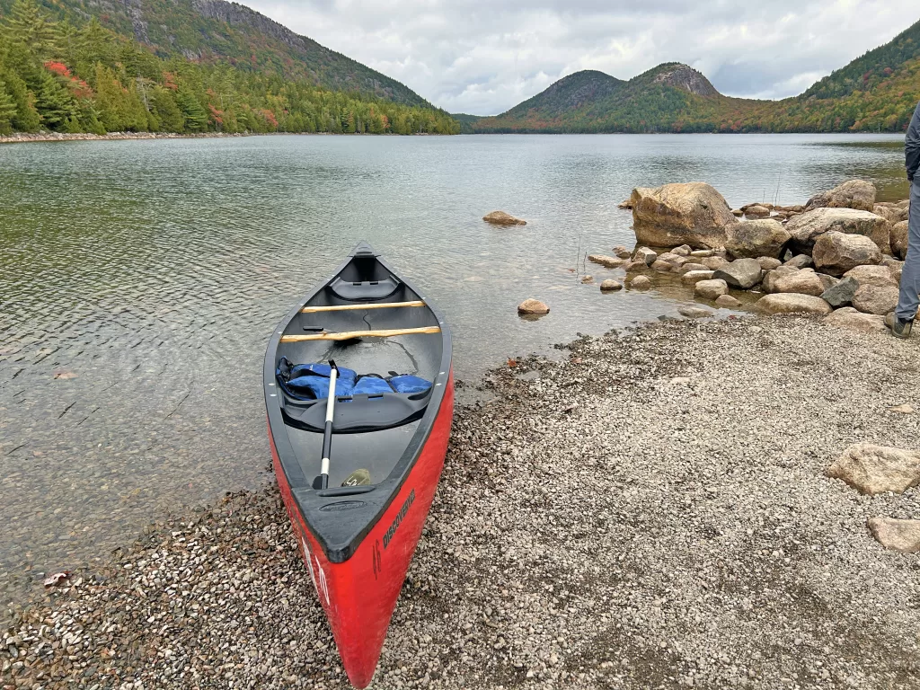 Canoe on the Jordan Pond beach with mountains in the background
