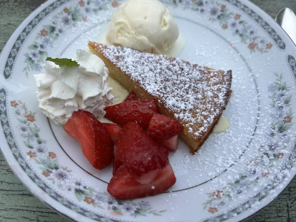 Olive cake with strawberries and ice cream on the side