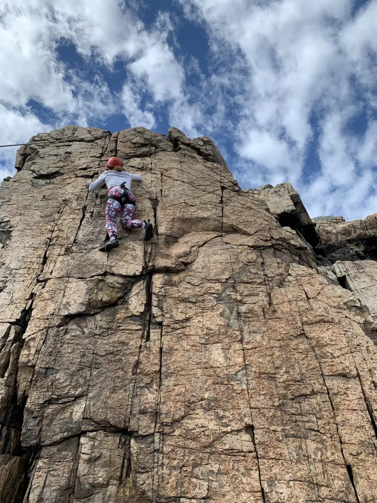 Woman climbing a cliff