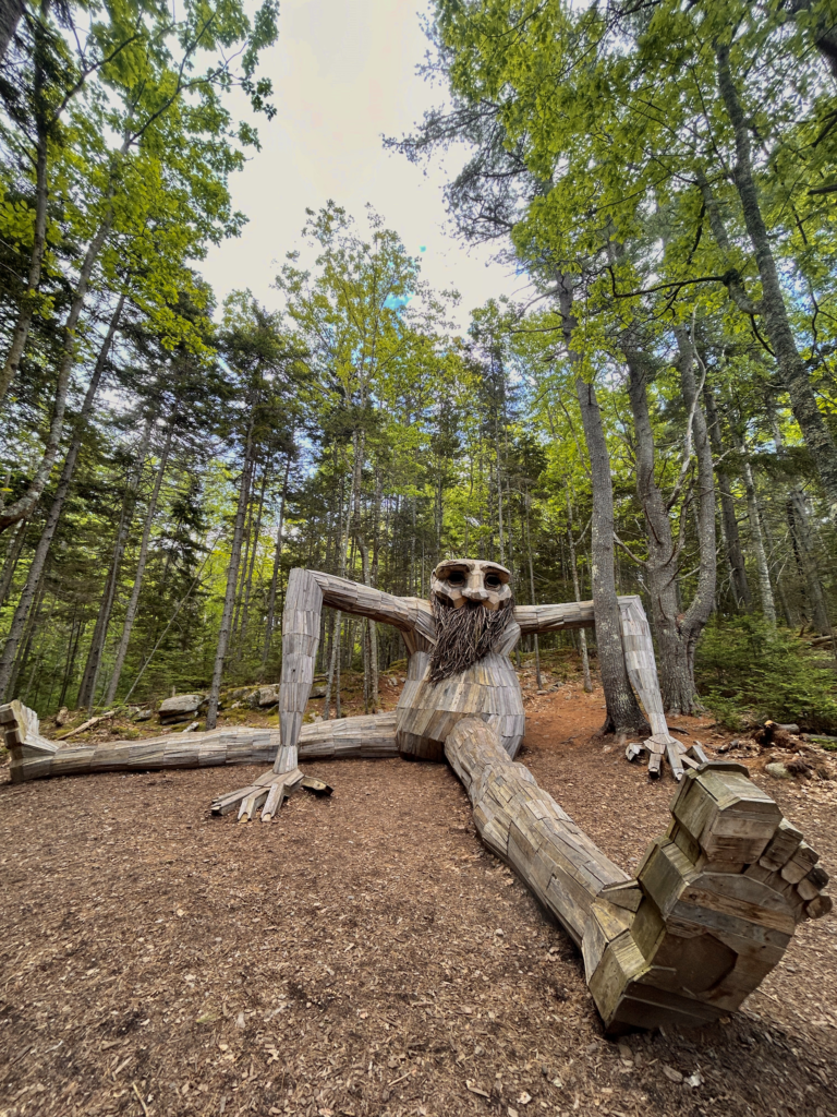 Image of a giant troll in the woods at Coastal Maine Botanical Gardens