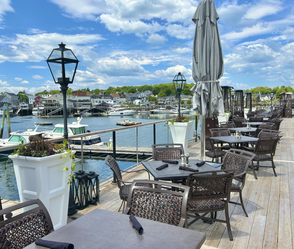 Image of the Coastal Prime restaurant patio with views of the harbor