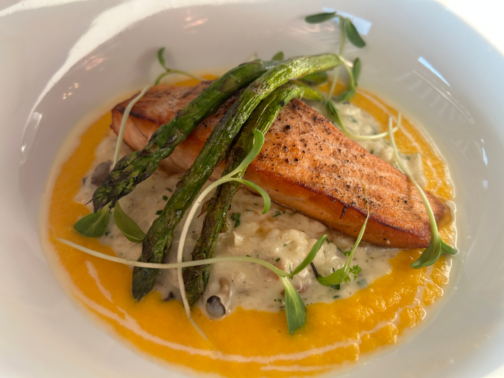 Image of grilled salmon, rice and asparagus on a plate from Hurricane restaurant
