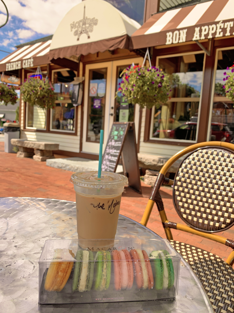 Image of the Mornings in Paris cafe with a drink and macaroons in the foreground