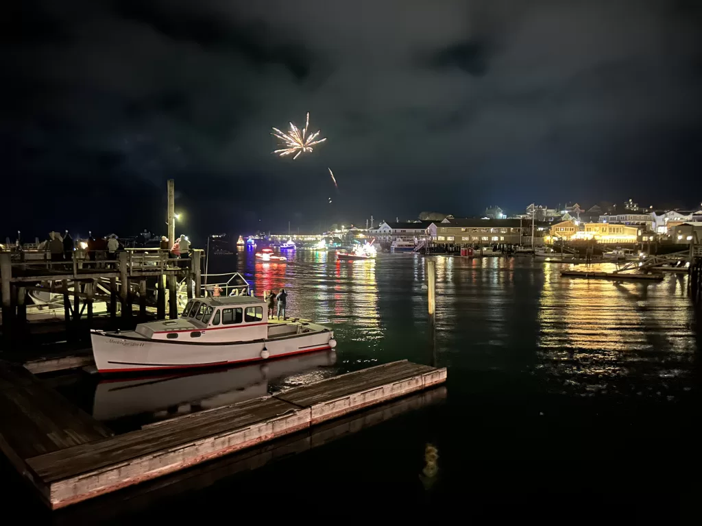 Harbor in the night with fireworks in the sky